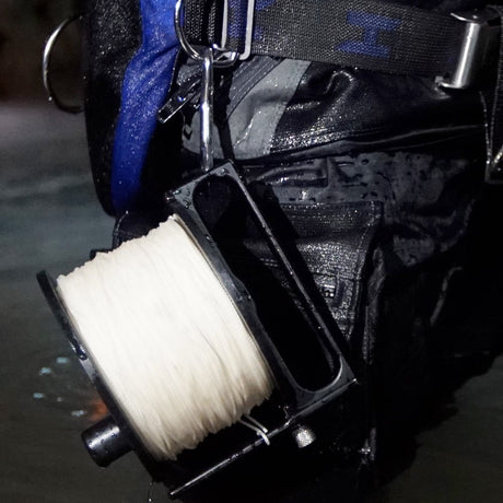 Halcyon Pathfinder 800 reel clipped to a diver's harness